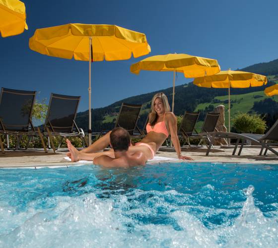 Couple bathing in the outdoor pool