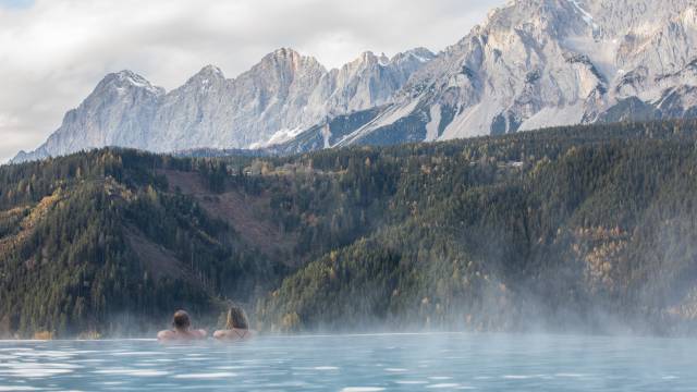 Paar im Infinity Pool mit Blick auf das Dachsteingebirge