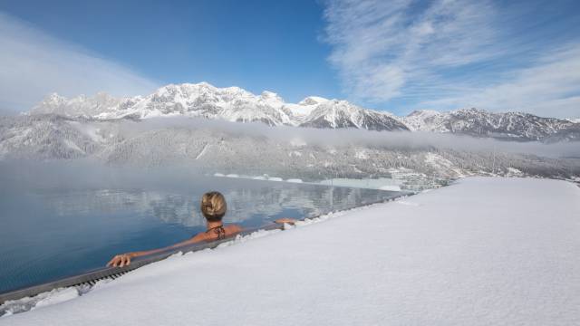 Frau im Infinity Pool mit Bergblick